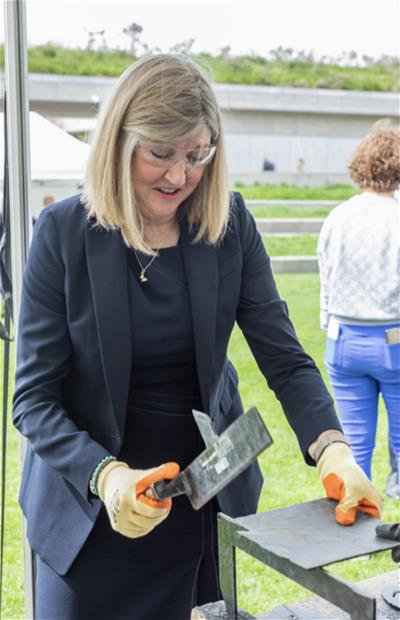 Alison Johnstone MSP, Presiding Officer of the Scottish Parliament, tries her hand at slate cutting
